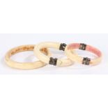 Three ivory Papua New Guinea currency bracelets, two with hinged fittings, the largest 9cm in