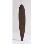 An Australian / Aboriginal bullroarer (rhombus, or turndun) carved extensively to one side and