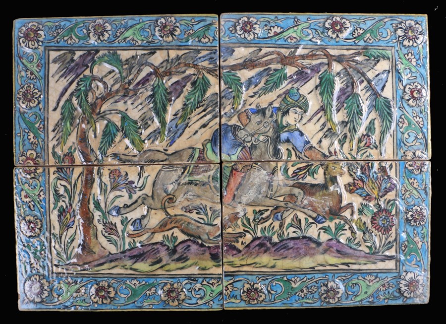 Large Persian moulded pottery tile, Qajar, with a figure on horseback hunting with a dog, an