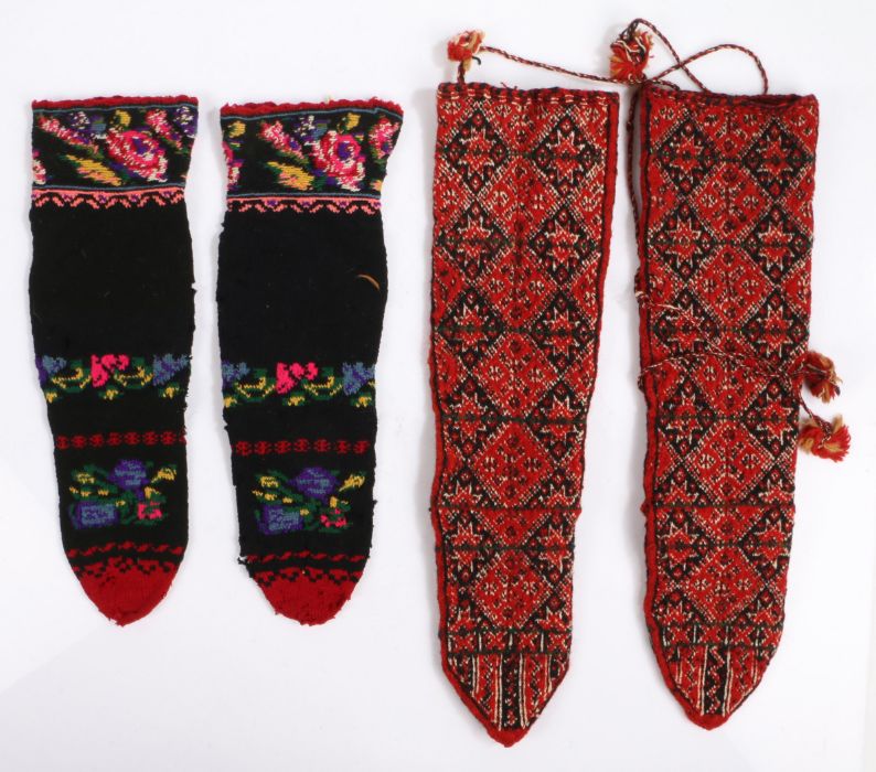 Two pairs of Greek sock boots, the first woollen pair in red with a geometric design, the second