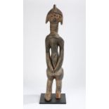 Sierra Leone Mende standing figure, the head with carved linear decorations, above a ringed neck,