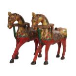 Pair of Rajasthani model horses, in bright polychrome and patterned saddles above red legs, 43cm