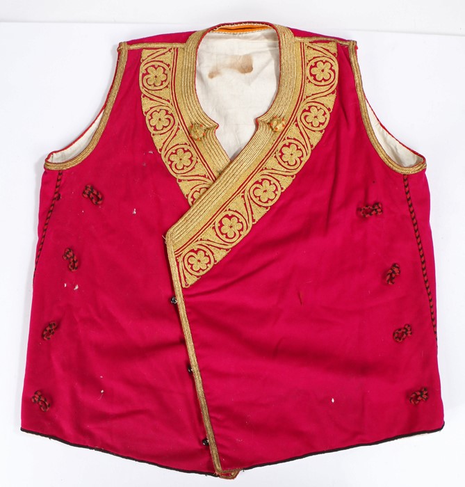 Greek bullion waistcoat, with vibrant gilt thread tot he collar and edge to the purple coat.