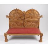 Rajasthani carved hardwood low bench, the dual arch carved back with birds above a roundel and a