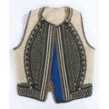 Greek waistcoat, with dome edge to the geometric line decoration on the coarse wool backing.