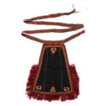 Greek apron, with a deep red edge and multicoloured trim to the scroll wool designs to the black