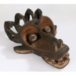 Large Mambila mask, Cameroon, the stylistic face surmounted by four animals, above an open mouth