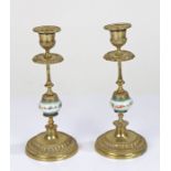 Pair of brass candlesticks, with a polychrome painted ceramic design of flowers to the stem (2)
