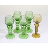 Set of four green roemer glasses, the bowls with etched fruiting vine decoration above strawberry