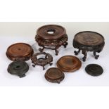 Collection of hardwood Chinese stands, of varying sizes and styles, the largest 19.5cm diameter