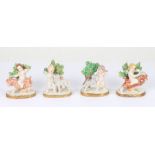 Four 19th Century continental porcelain putti figures, two with goats and two with lambs, 8.5cm high