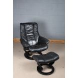 Black leatherette upholstered swivel chair with matching footstool (2)
