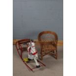 Childs painted metal rocking horse, with wooden slatted seat, together with a childs wicker chair (
