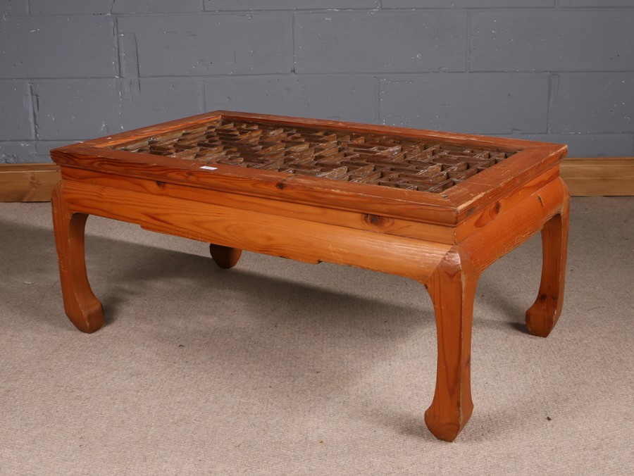 Chinese pine coffee table, of low rectangular form, having pierced geometric design top and raised