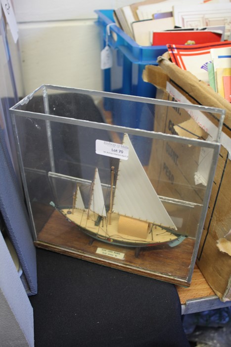 Small model three masted boat, with label 'Ghe Luoi Rung, Bob Nixon 91', housed within a glass