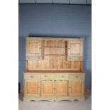Modern stripped pine and green painted dresser, the upper section having a pair of cupboards with