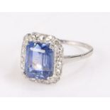 Sri Lankan sapphire and diamond set ring, the central 4.95ct sapphire surrounded by diamonds, ring