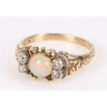 19th Century opal and diamond set ring, the central opal flanked by rose cut diamonds, ring size