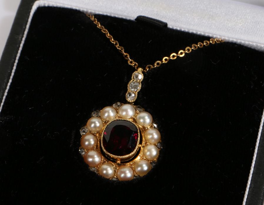 Diamond, garnet and pearl set pendant necklace, the central garnet with a pearl surround and