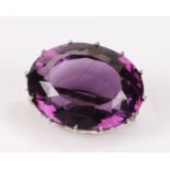 Amethyst set brooch, the facet cut amethyst mounted in a pierced white metal brooch mount, the