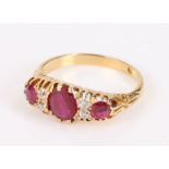 Ruby and diamond set ring, with three rubies at an estimated total weight of 0.82 carat divide by