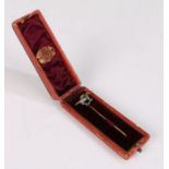 Gold stick pin, the terminal in the form of a diamond and set horse with ruby eye ridden by a jockey