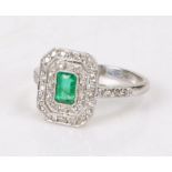 18 carat white gold diamond and emerald set ring, the central emerald at an estimated 0.44 carat and