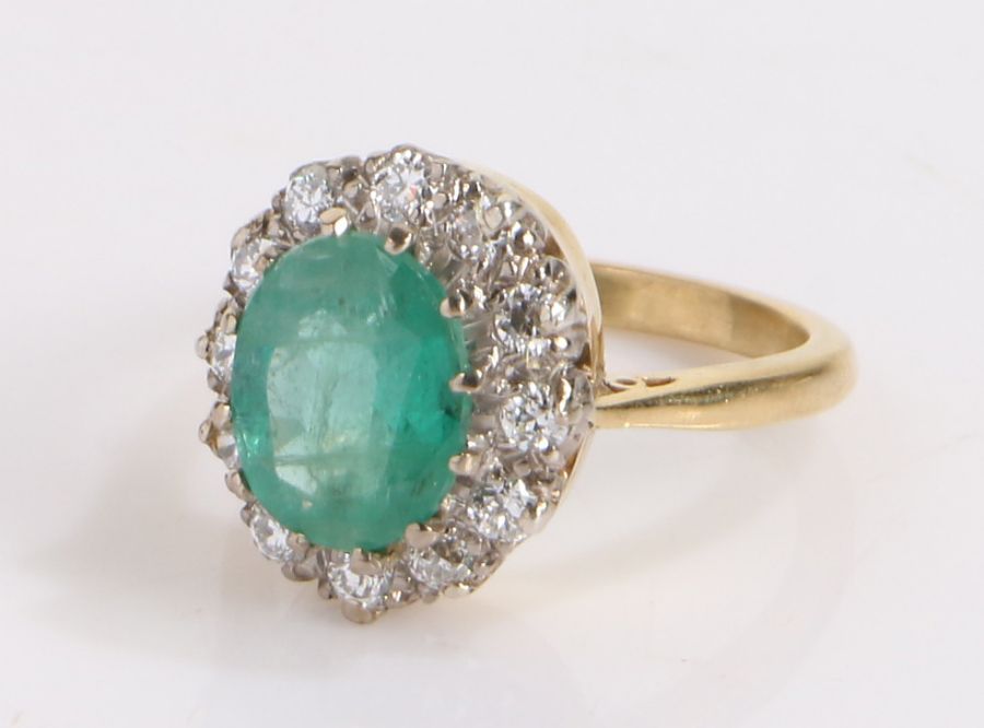 Emerald and diamond set ring, the central emerald at an estimated 2.42 carats and a diamond surround