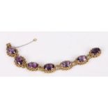 Gold bracelet set with seven facet cut amethysts, 20cm long, 42.4g