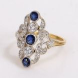 Diamond and sapphire set ring, with three round cut diamonds and a diamond surround at an