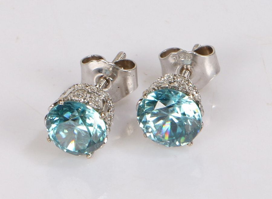 Pair of zircon and diamond ear studs, the pins set with a central zircon and pierced diamond set