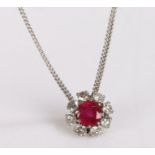 18 carat white gold, ruby and diamond pendant necklace, the central ruby at 1.22ct, surrounded by