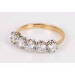 18 carat gold diamond set ring, with a row of five round cut diamonds totallign an estimated 1.55