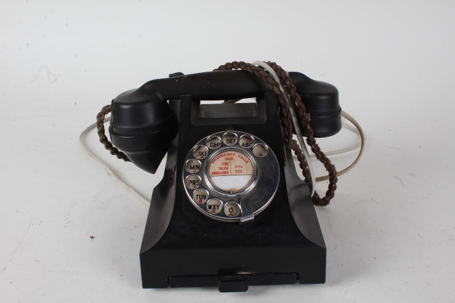 Black bakelite rotary dial telephone, with pull out tray