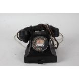 Black bakelite rotary dial telephone, with pull out tray