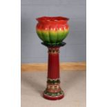 20th Century Majolica jardiniere on associated stand, the green and red glazed jardiniere with marks