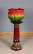 20th Century Majolica jardiniere on associated stand, the green and red glazed jardiniere with marks