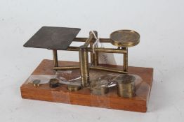 Set of 20th century brass scales, raised on oak base, 18cm wide