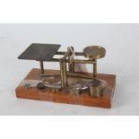 Set of 20th century brass scales, raised on oak base, 18cm wide