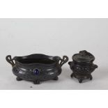Art Nouveau pewter and enamel twin handled pot, with stylised rim and body, inset with blue enamel