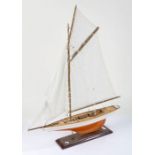 Model of a sailing Yacht, single mast raised on a stand