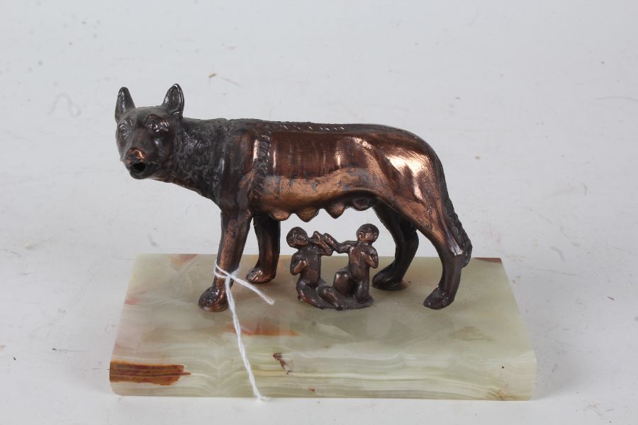 Romulus and Remus, bronzed figure group modelled suckling from a wolf, raised on an onyx rectangular - Image 2 of 2