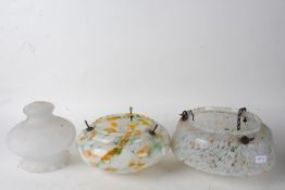 Three various Art Deco mottled glass light shades, two of circular form, the other with a frilled