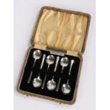 Set of six Art Deco silver plated coffee spoons, with tapering handles and shaped bowls, housed in a