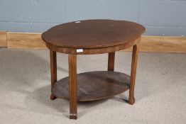 Art Deco walnut two tier table, having quarter veneered shaped top, 70.5cm wide x 50.5cm high