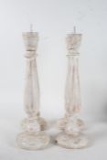 Four shabby chic pricket sticks, with tapering columns and circular feet, all approx. 45cm tall (4)