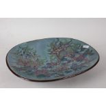 Chelsea Pottery, a large shallow dish, decorated flowers on a turquoise ground, raised on four feet,