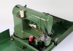 Elna sewing machine, in green, housed within a metal carrying case (sold as collectors item)