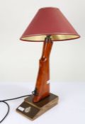 Novelty table lamp created out of the stock of a rifle, with an insignia to the base, 39cm high