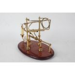 20th century brass and mahogany decanter stand, with candle sconce, 33cm wide
